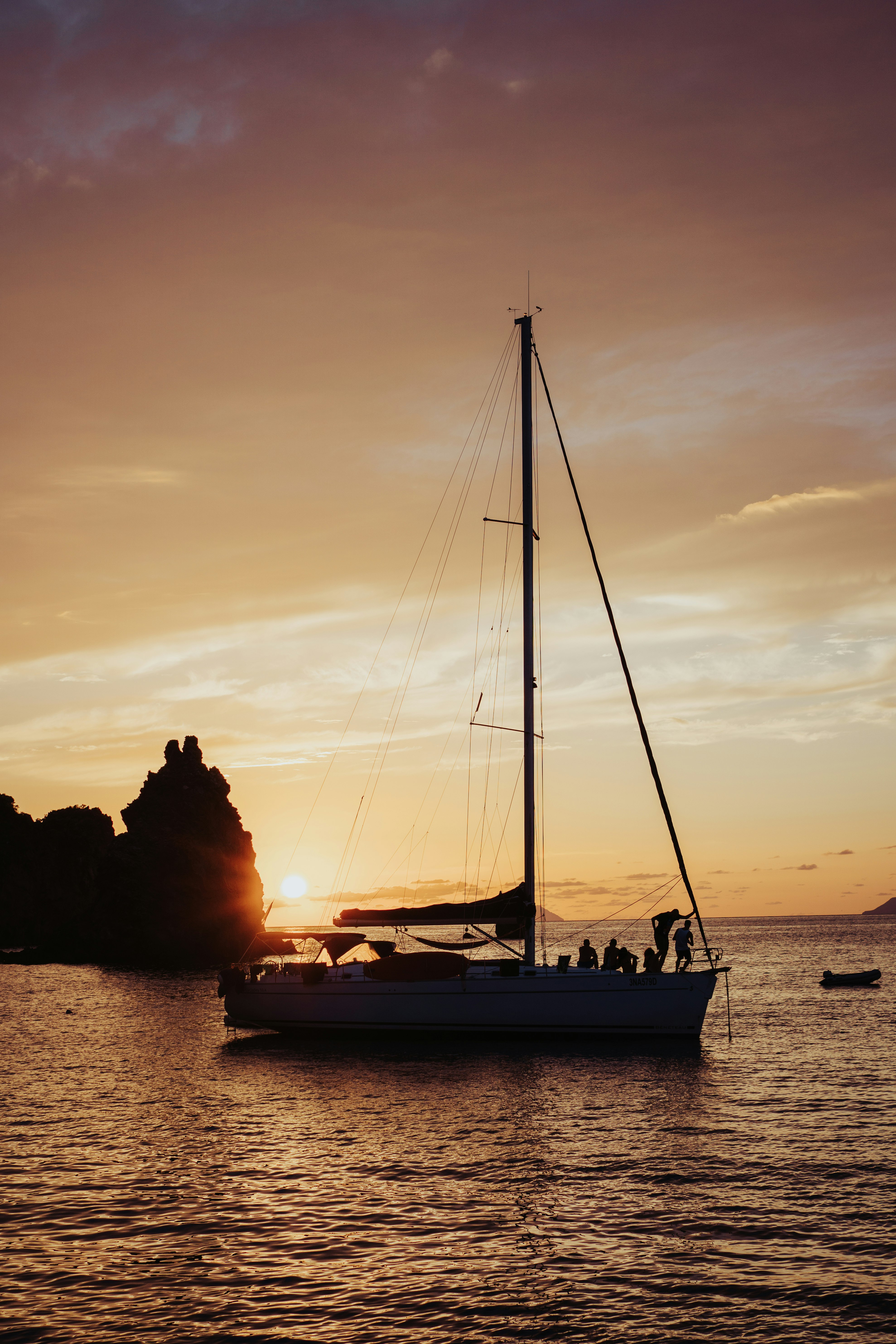 silhouette of people riding on boat during sunset